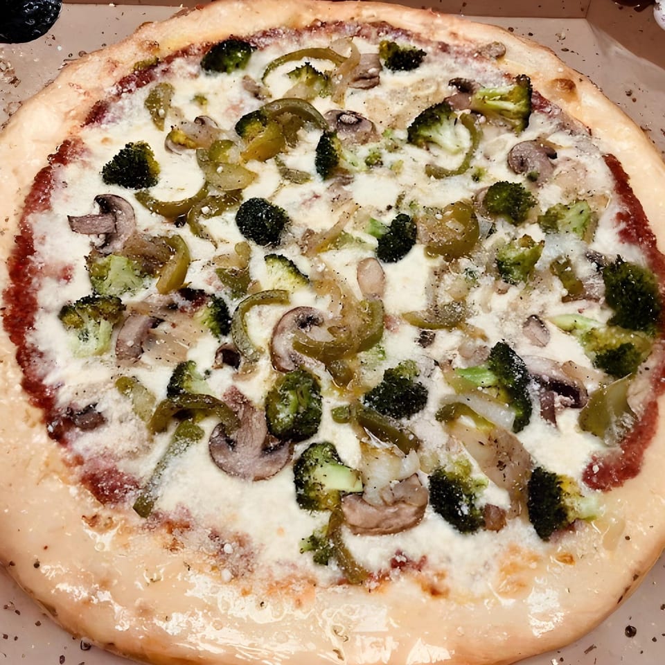 West End Kitchen & Catering's white pizza with broccoli, mushrooms, and green peppers.